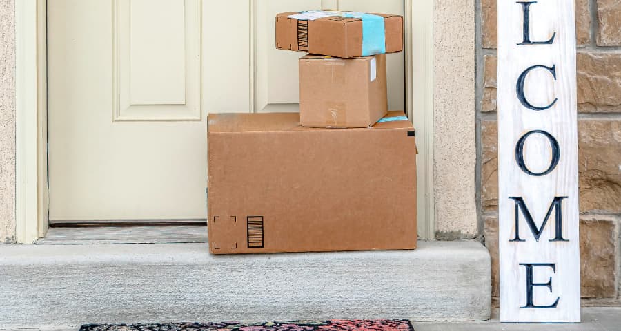 Boxes by the door of a residence with a welcome sign in Columbia